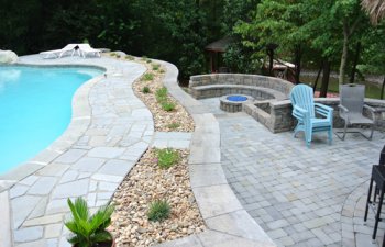 Stone patio with swimming pool and fireplace