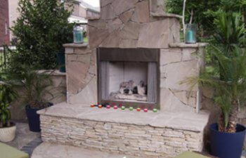 Patio with a stone fireplace