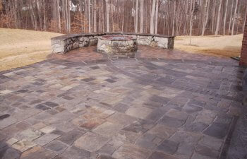 Stone patio with a fireplace