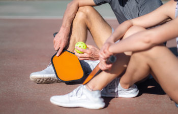 relaxing pickleball players sitting after game